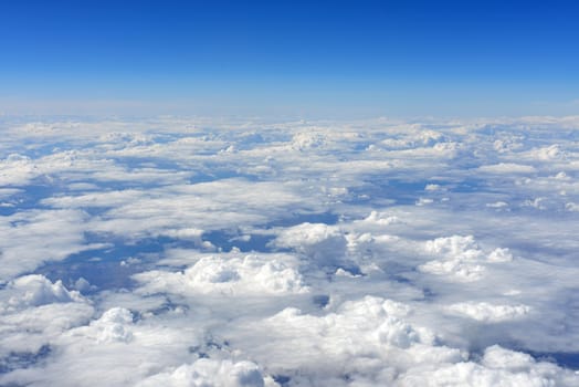 Blue sky and clouds. Top view of aircraft