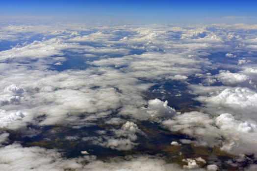 Blue sky and clouds. Top view of aircraft