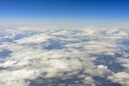 Blue sky and clouds. Top view of aircraft