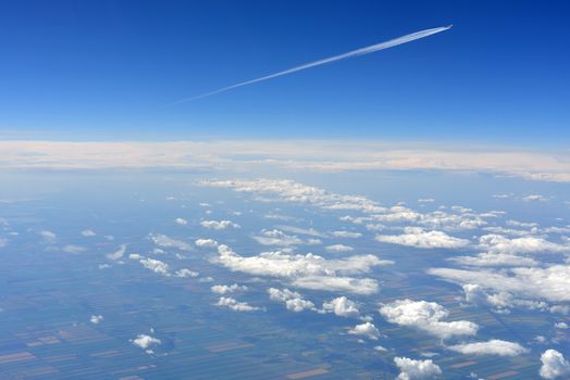 Blue sky and clouds. Top view of aircraft