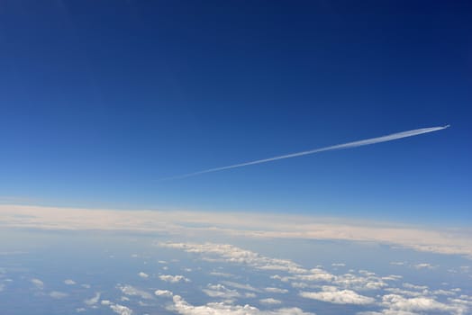 Blue sky and clouds. Top view of aircraft