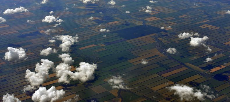 Earth's surface and clouds. Top view of aircraft