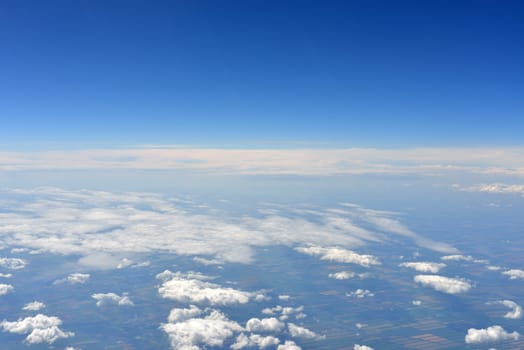 Earth's surface and clouds. Top view of aircraft