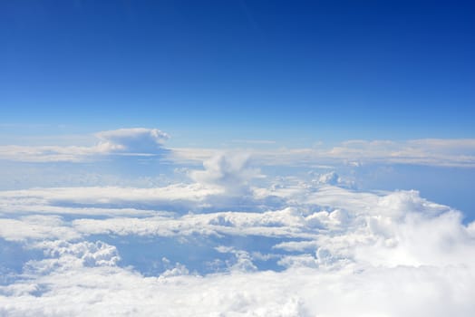 Blue sky and clouds. Top view of aircraft