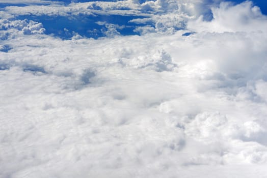 Blue sky and clouds. Top view of aircraft