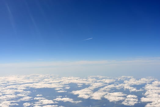 Blue sky and clouds. Top view of aircraft