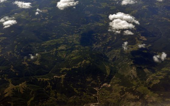 Earth's surface and clouds. Top view of aircraft