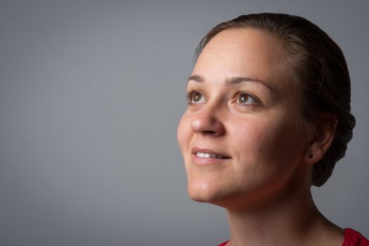 portrait of a smiling woman on grey background