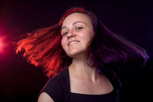 portrait of a smiling party woman with red and blue lights