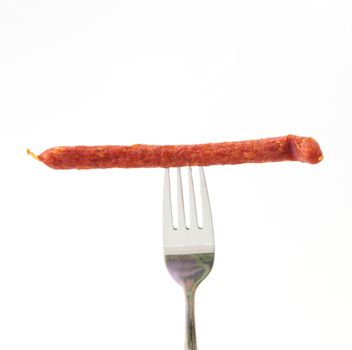 sausage on a fork isolated on white background