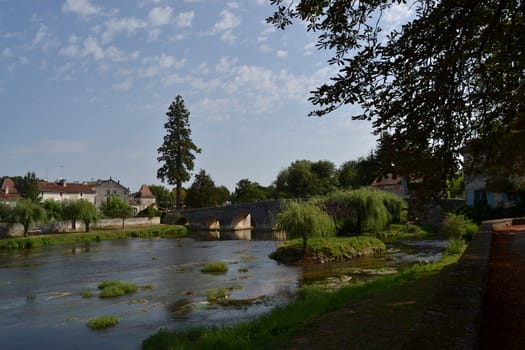 Dronne river passing through the village of Bourdeilles, France. Sunny day in summer