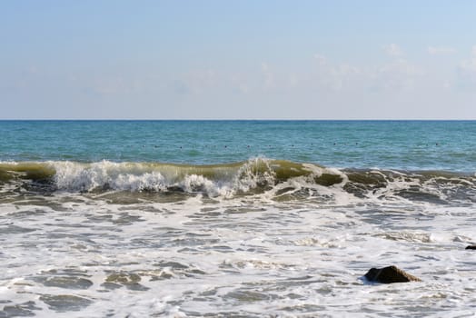 Sea wave rolled ashore. Blue sky in the background