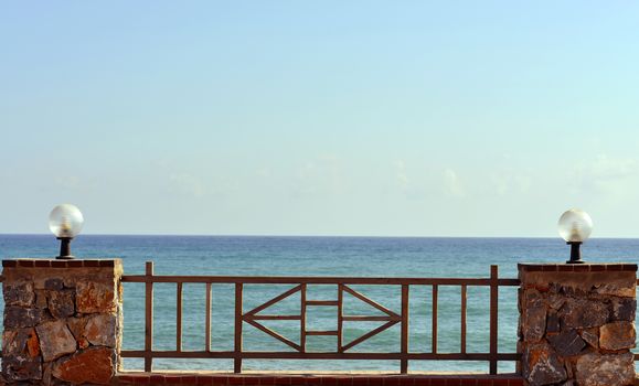 Railing with lights on background of sea and sky