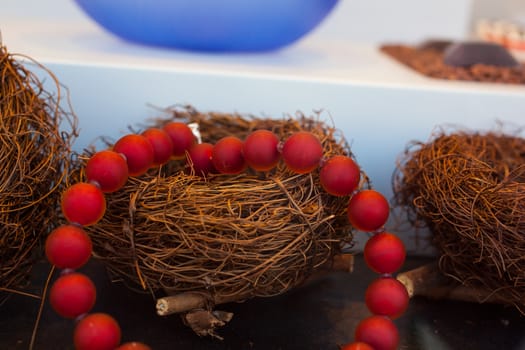 Close up of red pearls necklace on nest