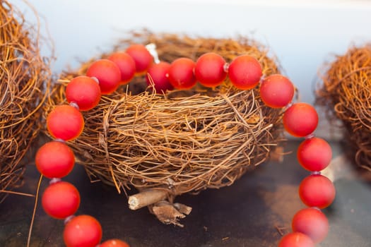 Close up of red pearls necklace on nest