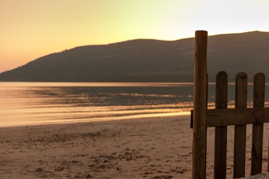 little fence on the beach in a spring sunset