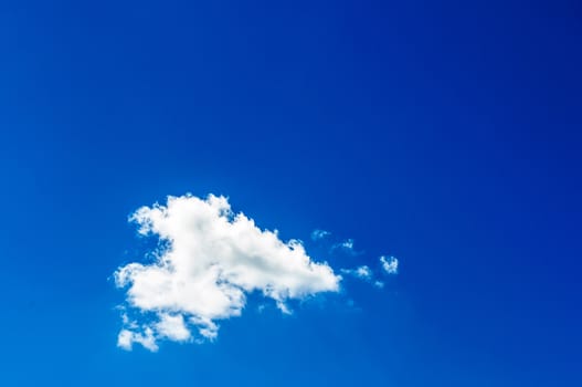 A small cloud in the blue sky of spring