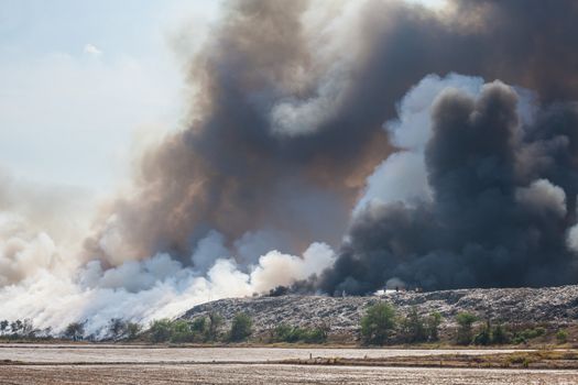 Burning garbage heap of smoke from a burning pile of garbage