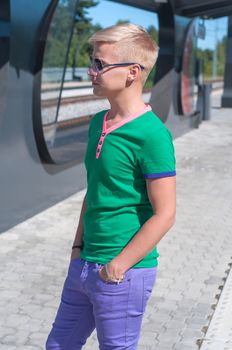 Shot of stylish man with sun glasses standing on train station