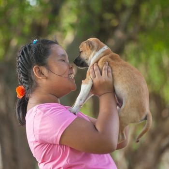 little asian girls and puppy in the garden