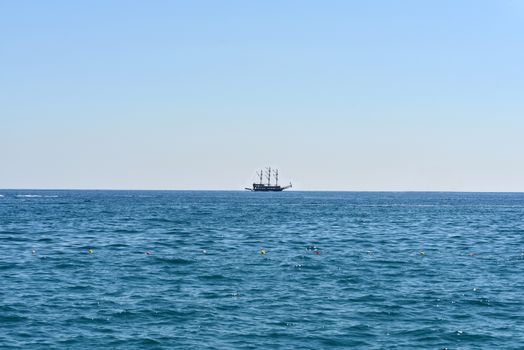 Old marine vessel in the sea. Blue sky on background