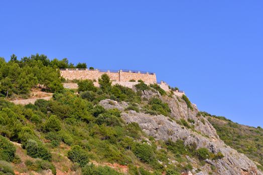 Mountain with castle against the blue sky