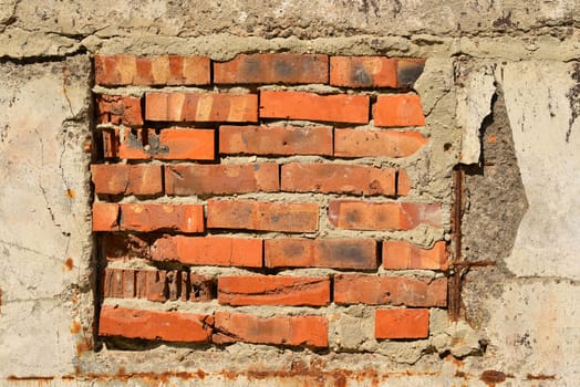 Old, cracked surface of concrete and bricks. Close up