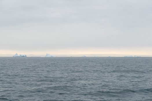 Seascape with icebergs around Disko Island on the ocean