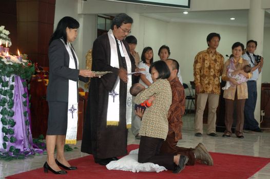 bandung, indonesia-december 19, 2010: Baptism - a christian rite of admission and almost invariably with the use of water, into the christian church generally and also a particular church tradition.