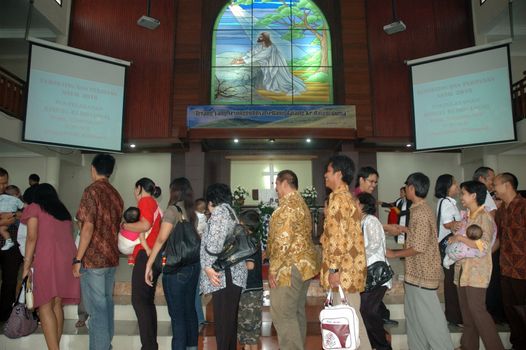 bandung, indonesia-december 19, 2010: church congregants that attend baptism ceremonial.