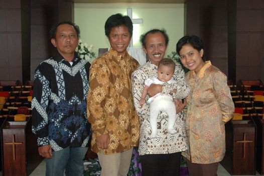 bandung, indonesia-december 19, 2010: family portrait after baptism ceremonial.