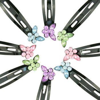 Black hair clip with colorful butterfly put as circle isolated on white background.