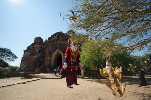 Burmise traditional puppet in front of ancient pagoda, Myanmar