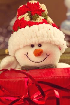 Christmas and New Year snowman snowman with gift on snow background
