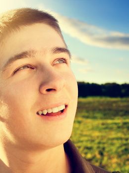 Toned photo of Happy Teenager portrait at the Field