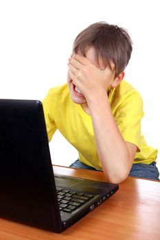 Sad Kid weeps behind Laptop Isolated on the White Background