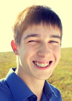 Toned photo of Happy Teenager portrait at the Field