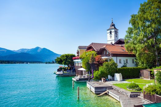 View of View of St. Wolfgang chapel and the village waterfront at Wolfgangsee lake, Austria