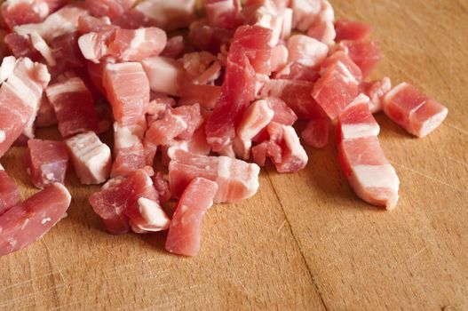 Bacon cubes on wooden board