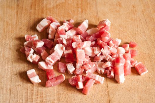 Bacon cubes on wooden board