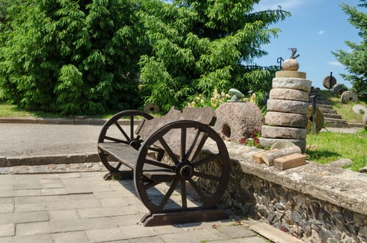 bench with wheel carriage rails stacked tower cement millstones