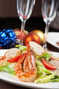 Tasty shrimp salad with vegetables on christmas table