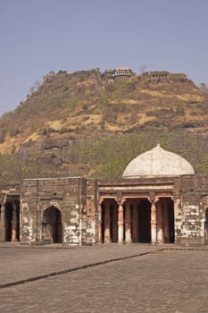 Mosque inside Daulatabad Fortress, India. Citadel of the fort on the hilltop in the distance. 14th Century AD