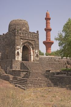 Entrance to the Mosque inside Daulatabad Fortress, India. Islamic victory tower (Chand Minar) in the background. 14th Century AD