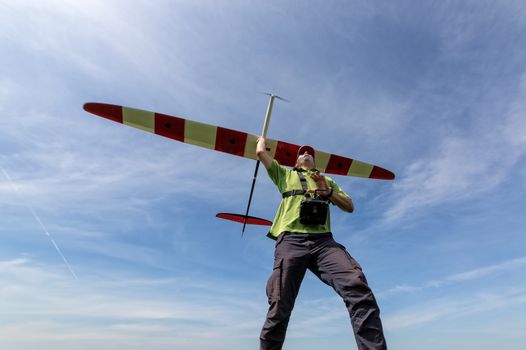 Man launches into the sky RC glider, wide-angle