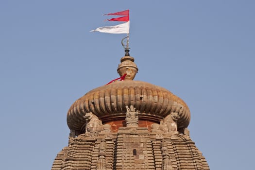 Main tower of the Lingaraja Hindu Temple. Ornately carved building with flags flying from the top. Bhubaneswar Orissa India. 11th Century AD