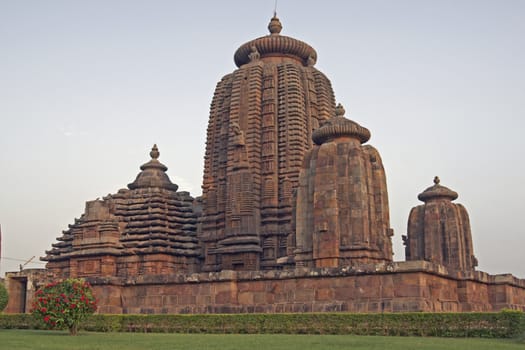 Ancient Hindu Temple (Brahmesvara Temple). Ornately carved building with multiple towers inside a walled compound. Bhubaneswar Orissa India. 11th Century AD