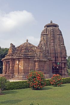 Ancient Hindu Temple (Rajarani Temple). Ornately carved building with large tower set in landscaped gardens. Bhubaneswar, Orissa, India. 11th Century AD