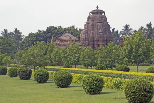 Ancient Hindu Temple (Rajarani Temple). Ornately carved building with large tower set in landscaped gardens. Bhubaneswar, Orissa, India. 11th Century AD