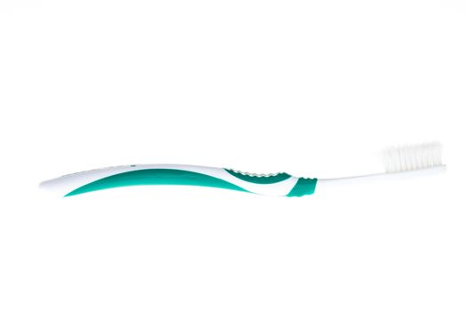 Green worn toothbrush on white background